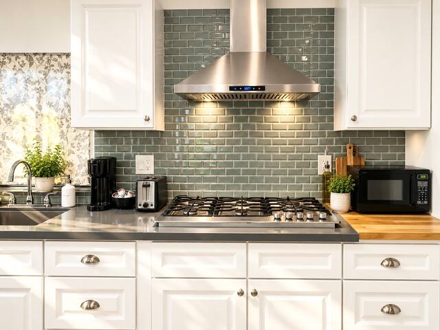 1 Bedroom Guest House Villa - HV2 kitchen with white cabinets and gas range